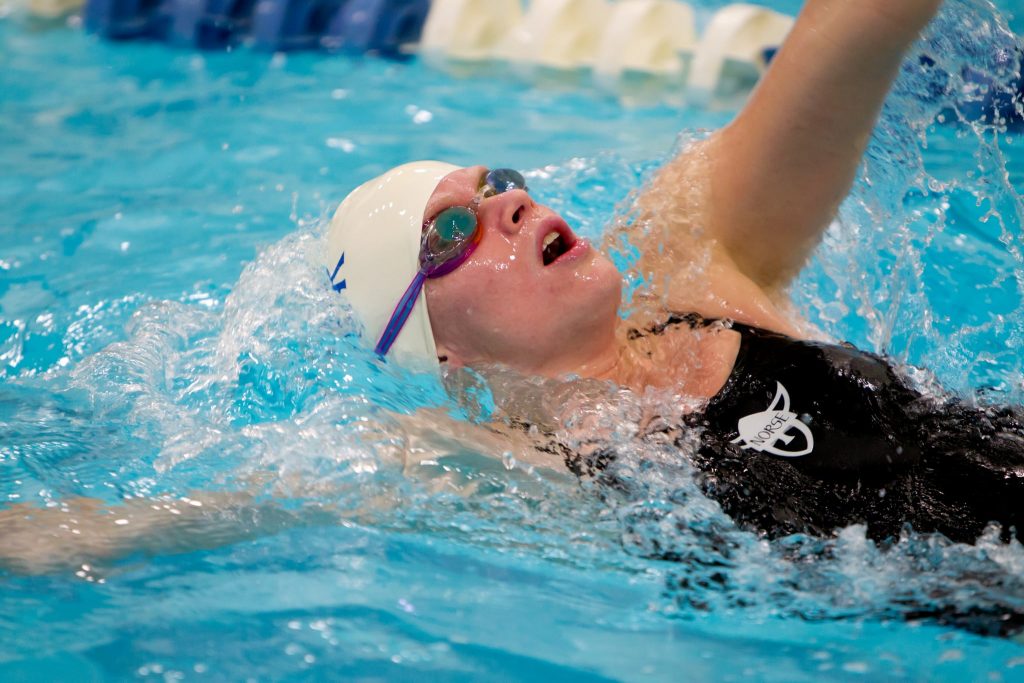 a girl swims on her back