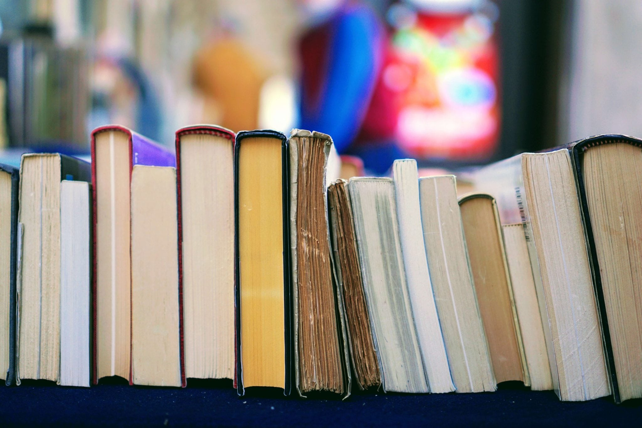 Picture of a stack of books laying on their side.