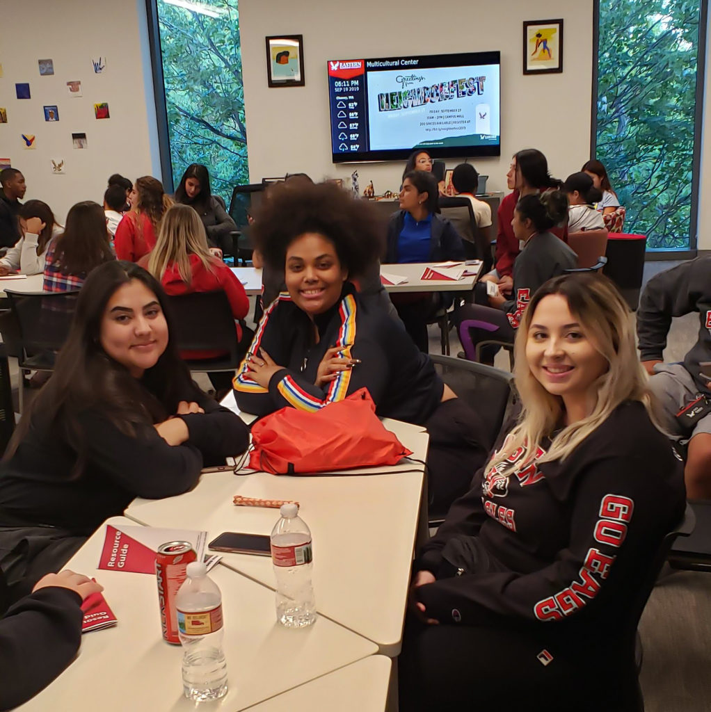 students smiling while hanging out at Multicultural center