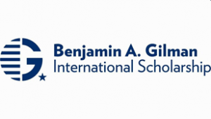 Capital G with lines covering the left half of the G next to, blue text on white background: Benjamin A. Gilman International Scholarship