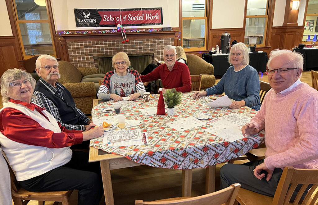 Retirees at a table playing games.