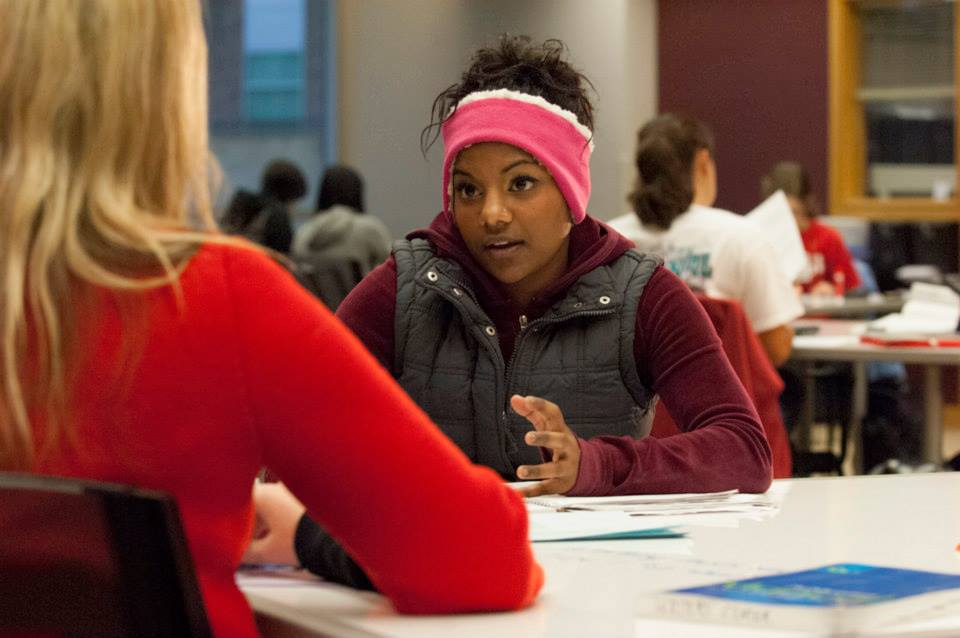 photo of girl at table in library