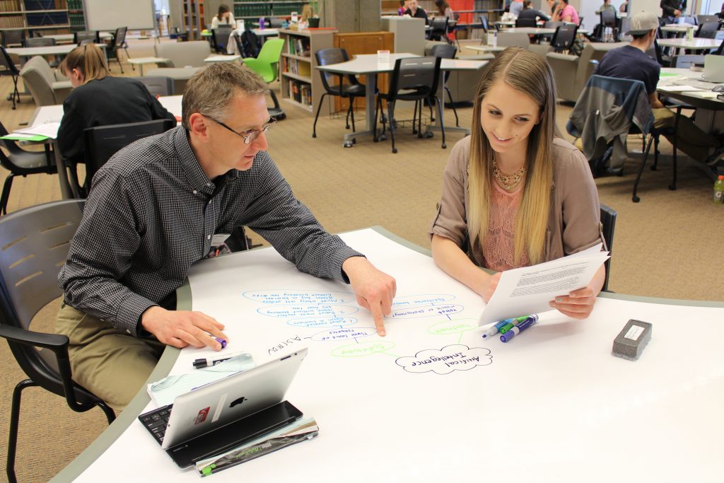 photo of two people working together at the library