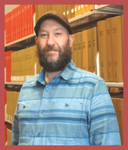 Responder standing in front of a bookshelf